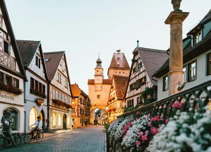 River cruise ship moored below a historic European old town